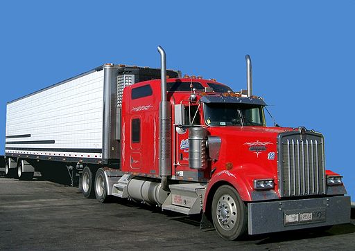 Red semi-truck with white trailer