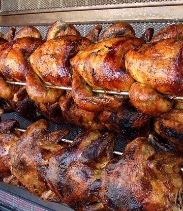 8 rotisserie chickens on spit.