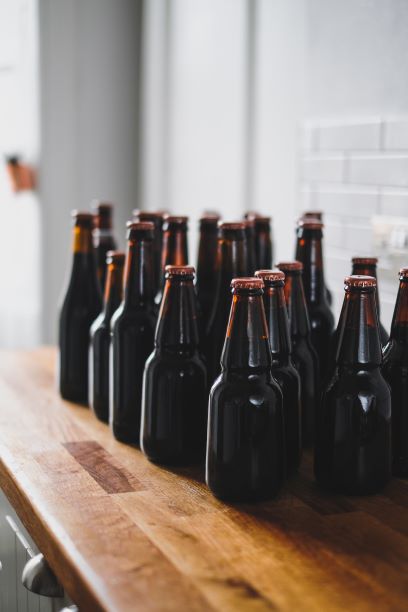 Brown beer bottles on wooden counter