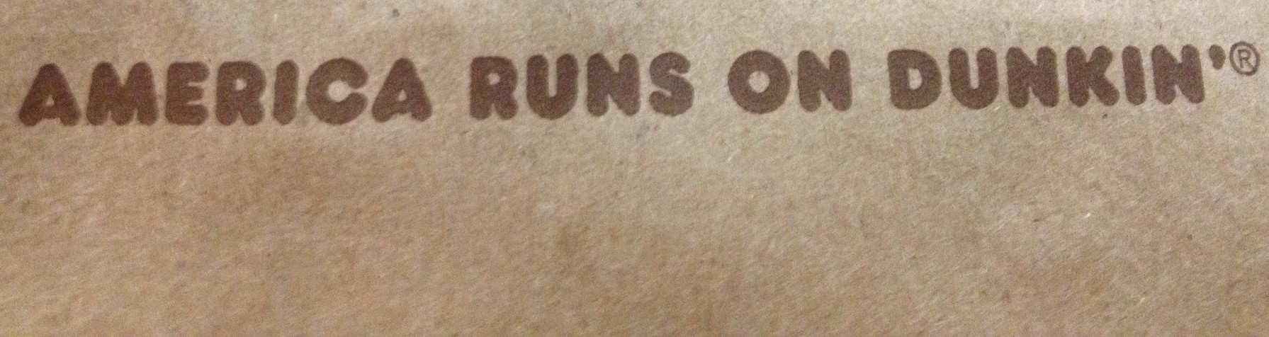 "America Runs on Dunkin'" on brown paper bag