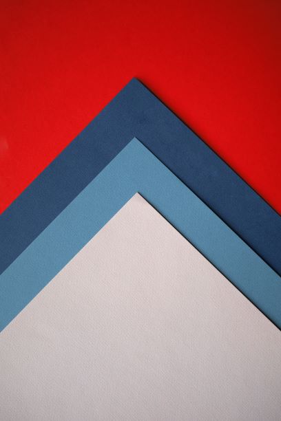 red, dark blue, light blue and white paper turned so that corners pointing up like arrow