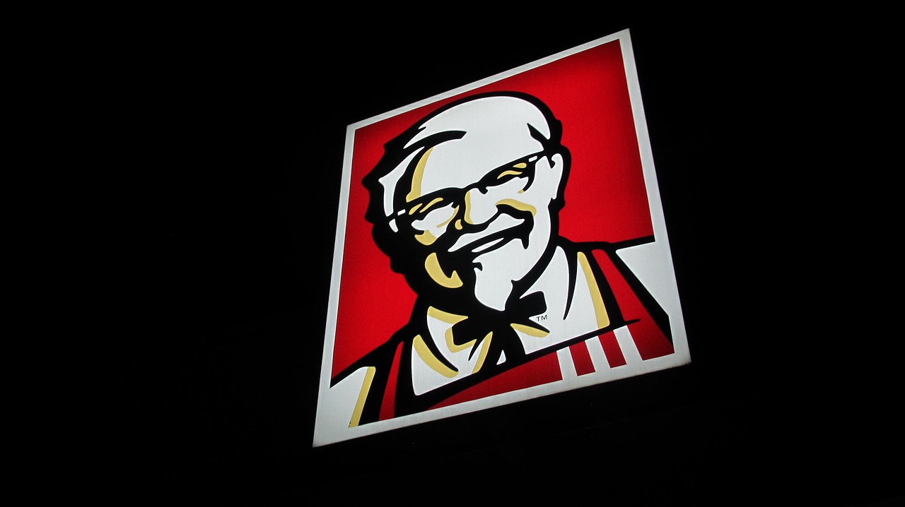 KFC sign at night against dark sky.