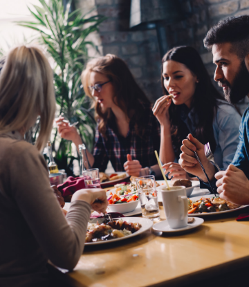 Supply Chain Scene, image of people laughing, eating, at a restaurant 