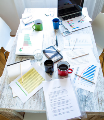 Supply Chain Scene, image of papers and work spread out on a restaurant table