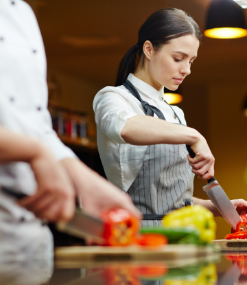 Supply chain Scene, image of kitchen workers cutting vegetables