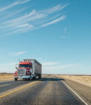 Supply Chain Scene, image of a big truck on the highway with blue skies 