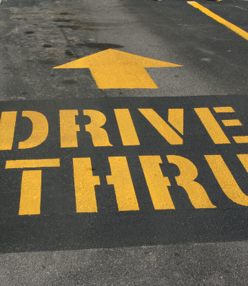 Supply Chain Scene, image of DRIVE THRU spray painted on pavement 