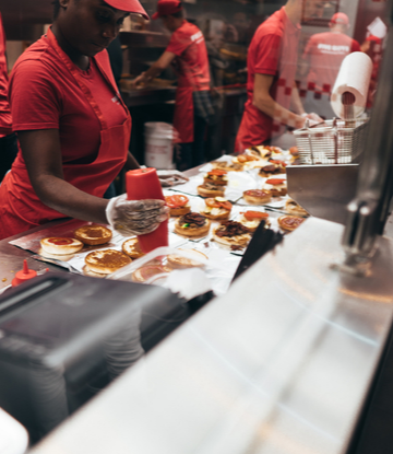 Supply Chain Scene, image of line cooks making food in a restaurant kitchen 