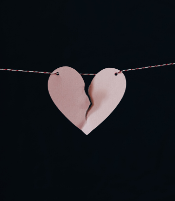 SCS, image of a paper heart split in half on a string
