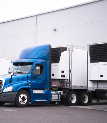 SCS, image of a reefer truck backed up to a referigerated warehouse for loading 