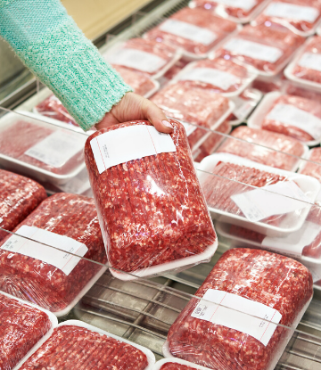 SCS, image of a hand pulling packaged meat out of a supermarket case 