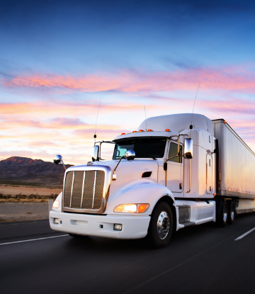 SCS, image of an 18-wheeler reefer at sunset on the highway