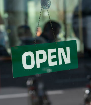 SCS, image of an OPEN sign on a glass door 