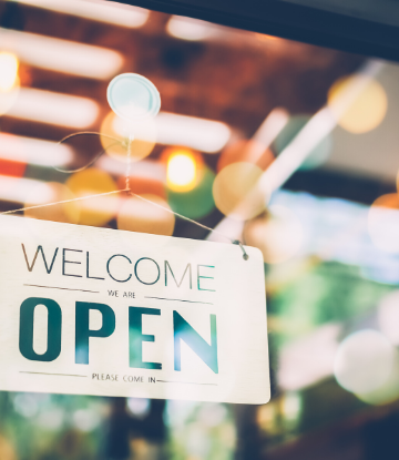 SCS, image of an OPEN sign on the glass of a restaurant 