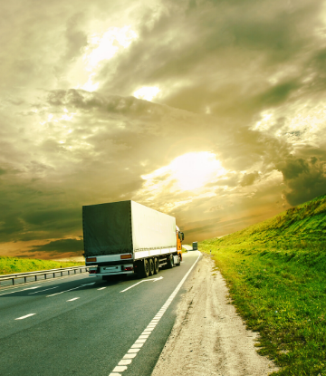 SCS, image of a large truck on the highway at sunset