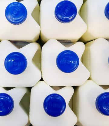 SCS, image of gallons of milk with blue plast lids 