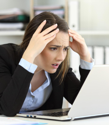 Photo of suprised woman looking at her computer screen 