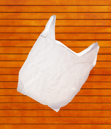 Image of a plastic bag floating in the air against an orange background 