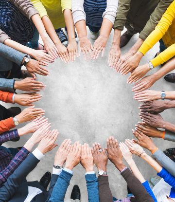 Overhead image of hands together in a cirlce 