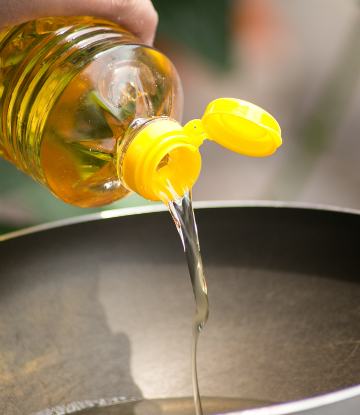 Image of cooking oil being added to a pan 