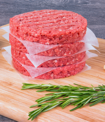 raw hamburger patties stacked 