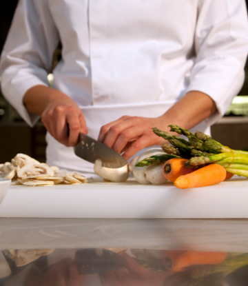 kitchen worker prepping fresh vegetables 