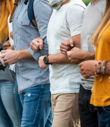 People with arms locked together standing