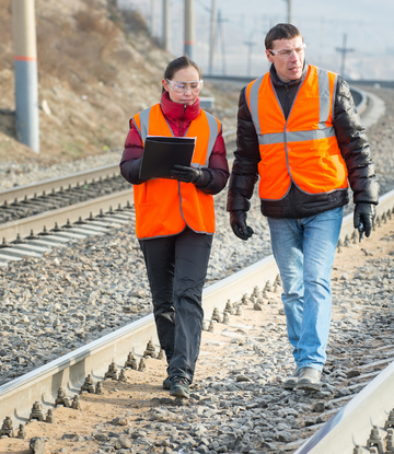 Rail workers walking the train tracks 