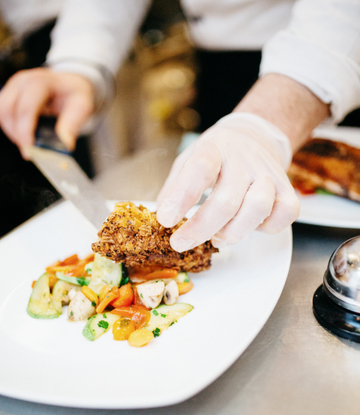 Food server wearing a glove 