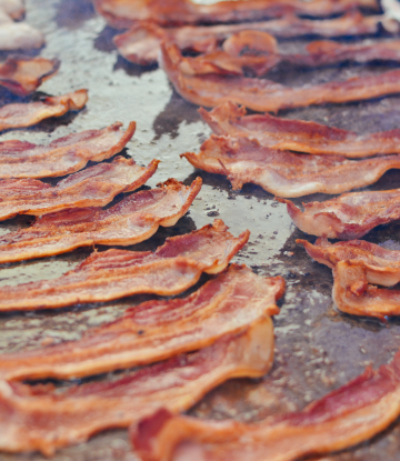 Bacon cooking on a flat top