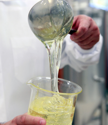 corn syrup being ladeled in to a glass container 